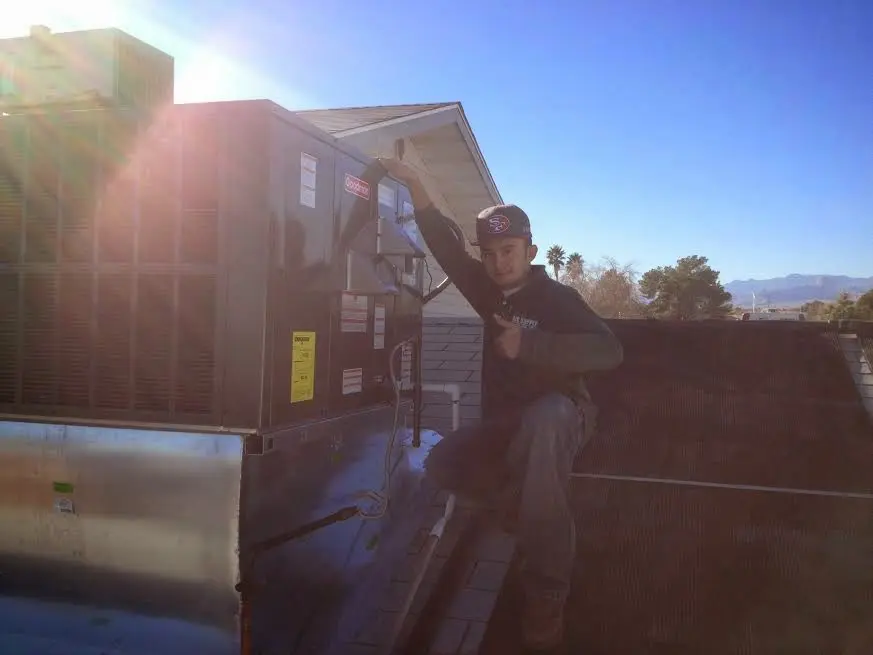 HVAC technician performing HVAC Inspection on a rooftop unit in Winnemucca